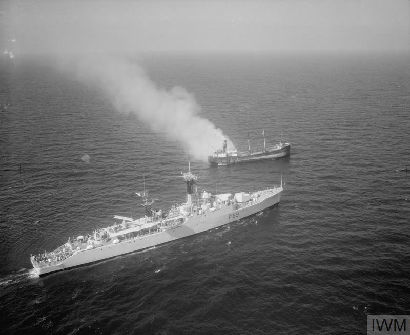 NAVY SAVES CREW FORM BURNING COASTER. SEPTEMBER 1958, VIEW FROM A HELICOPTER. THE FRIGATE HMS CHICHESTER PICKED UP THE CREW OF THE SMALL COSTA RICAN COASTER CONCHA, WHICH BURST INTO FLAMES AFTER AN EXPLOSION OFF THE PEMBROKESHIRE COAST.
